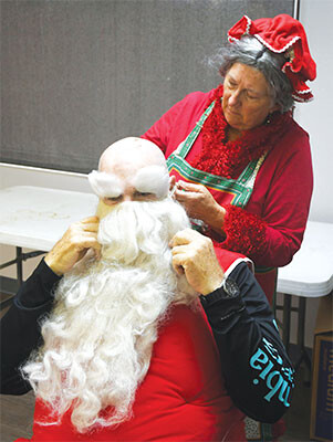 Mrs Claus dressing Santa web